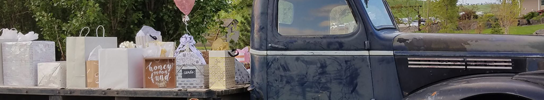 Old pickup truck being used as a gift table at a wedding